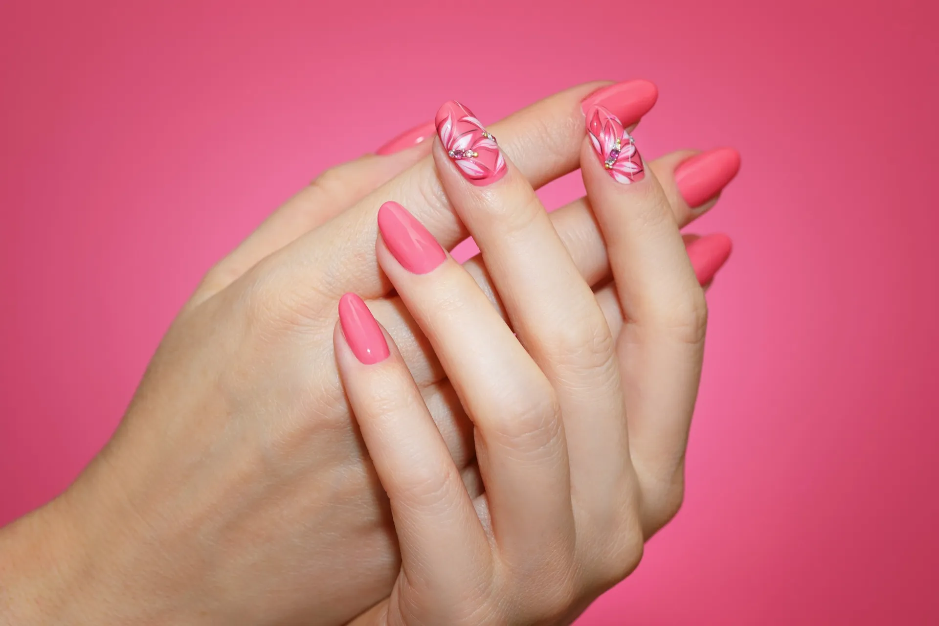close up manicured woman's nails with pink nail art